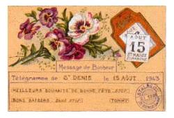 Carte télégramme sur papier orange, envoyé le 15 aout 1943. Des dessins de fleurs roses et blanches illustrent le texte.